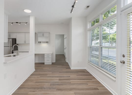 a kitchen with white walls and a large window at The Charleston, Columbus