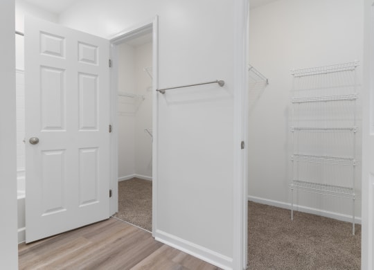an empty bedroom with a closet and a white door at The Charleston, Columbus, OH