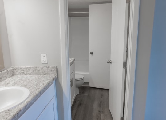 an empty bathroom with a sink and a toilet in it