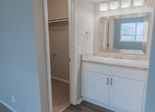 an empty bathroom with a sink and a mirror