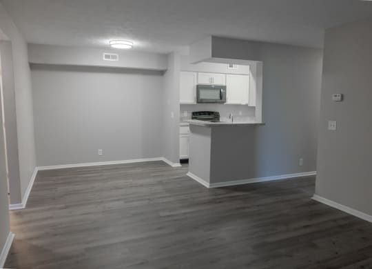 an empty living room and kitchen in a house