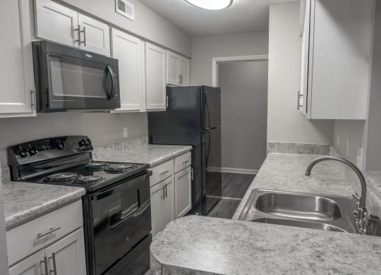 an empty kitchen with granite counter tops and stainless steel appliances