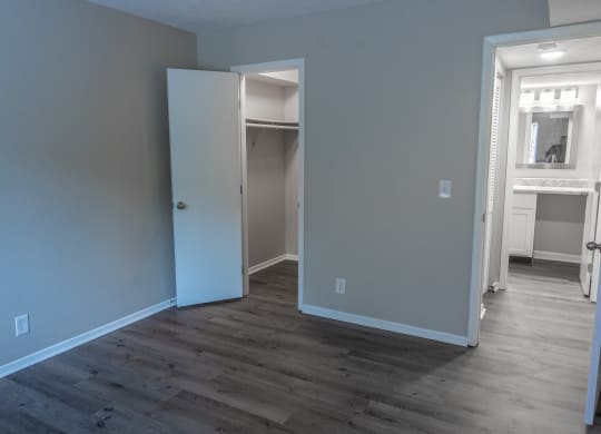a renovated living room with blue walls and a door to a closet