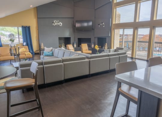 a large living room with couches and chairs and a table