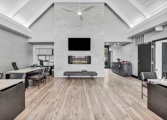 A modern living room with a fireplace and a television.