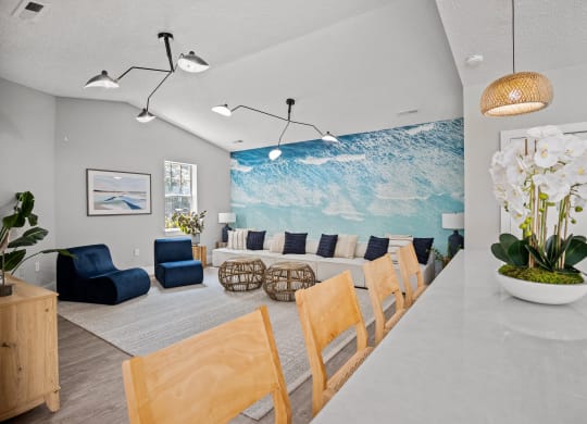 a room with a bunch of couches and chairs and a wall with a mural
