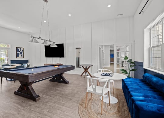 a living room with a pool table and a blue couch