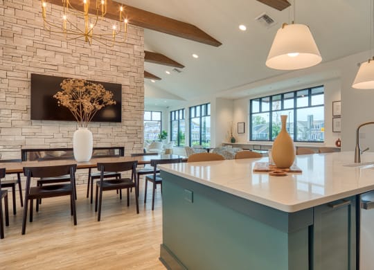 a kitchen with a large island and a dining room with a table and chairs at Allure at Edinburgh, Virginia