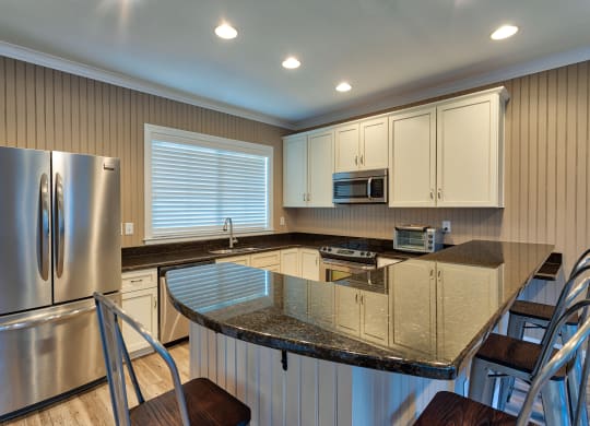 a kitchen with an island with a granite countertop
