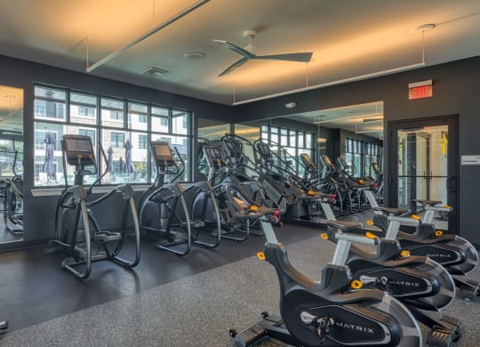 a gym with cardio bikes and other exercise equipment