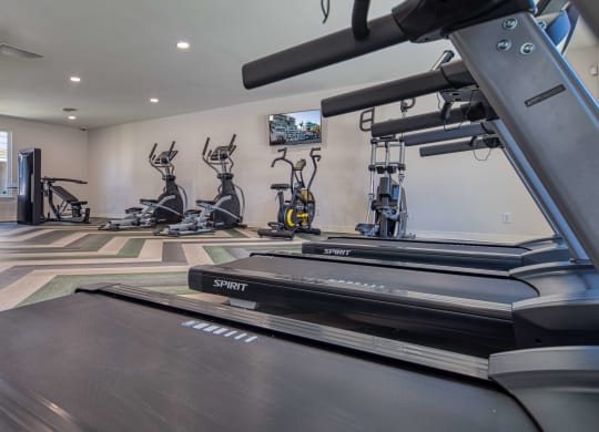 a gym with treadmills and other exercise equipment