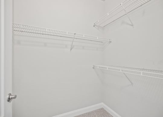 Empty white shelves in a room.