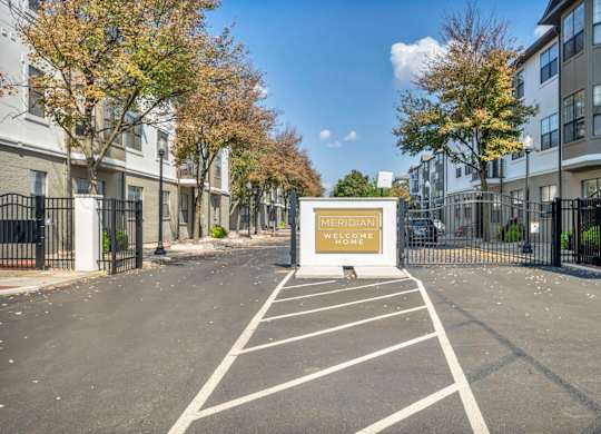 A Meridiani sign is displayed on a building in a parking lot.