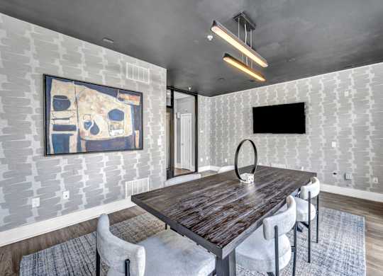 A dining room with a wooden table and chairs.