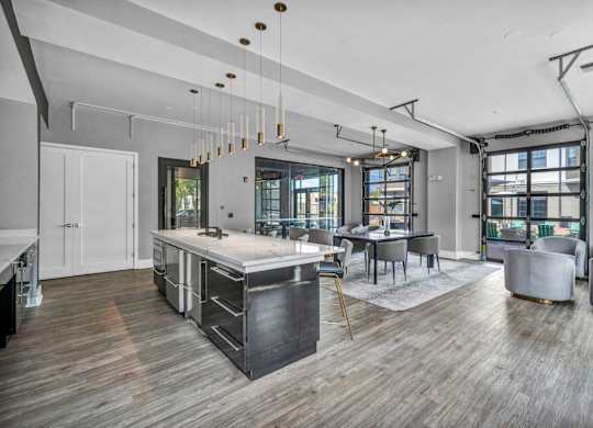 A modern kitchen with a wooden floor and a large island.