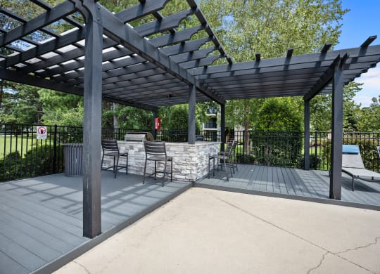 a patio with a seating area and a pergola