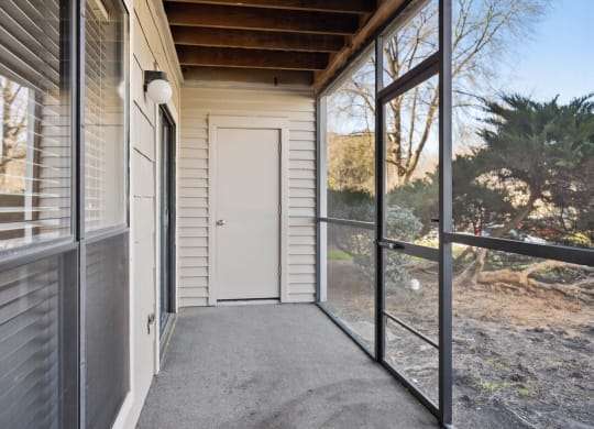 the front porch of a house with a white door