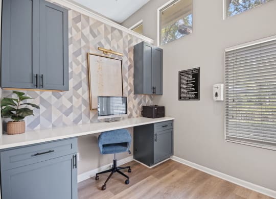 an office with a desk and a chair and a window