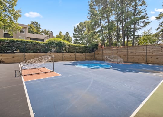 the backyard has a tennis court and a net