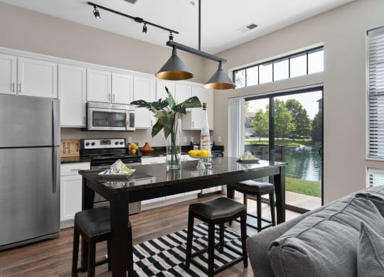 an open kitchen and living room with a stainless steel refrigerator at Hayden Lofts, Ohio