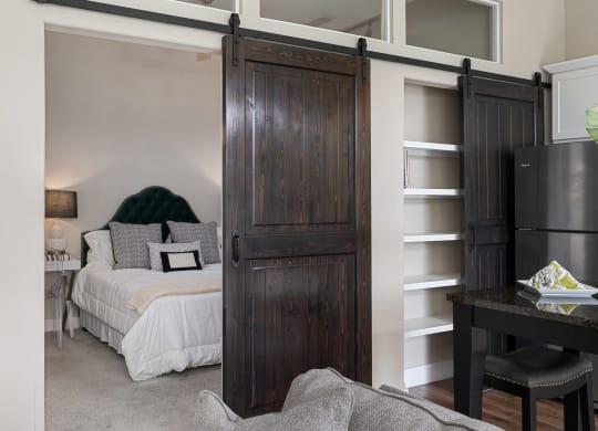 a bedroom with a bed and a sliding barn door at Hayden Lofts, Dublin, Ohio
