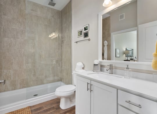 a bathroom with a sink and a toilet and a tub at Hayden Lofts, Dublin, OH