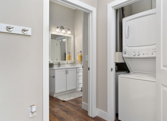 a laundry room with a washer and dryer and a bathroom with a sink at Hayden Lofts, Ohio, 43016