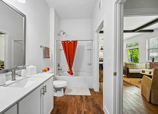 A bathroom with a white sink and a white toilet.