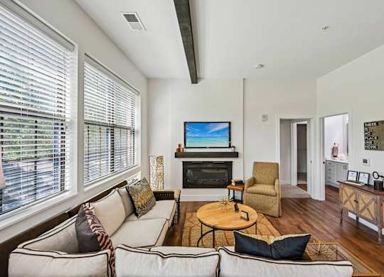 A living room with a white couch and a television.