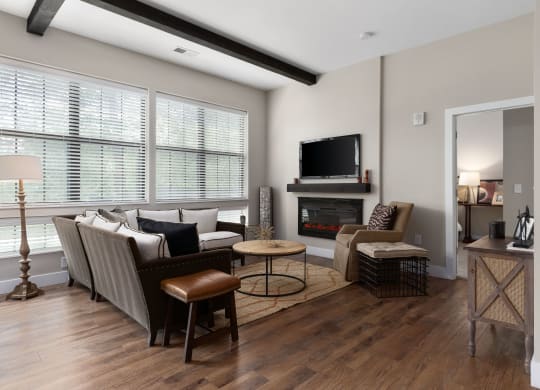 a living room with a couch and chairs and a fireplace at Hayden Lofts, Ohio
