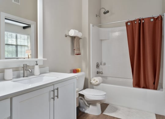 a bathroom with a shower toilet and sink and a mirror at Hayden Lofts, Dublin, Ohio