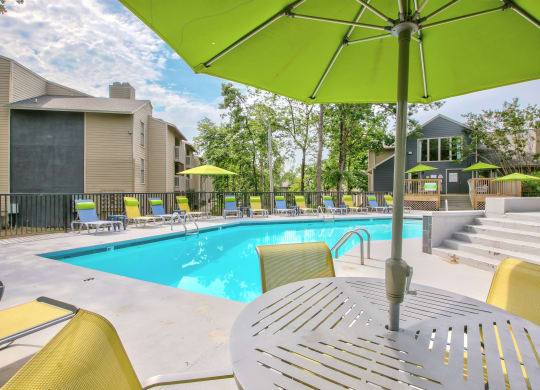 our apartments have a resort style pool with chairs and umbrellas