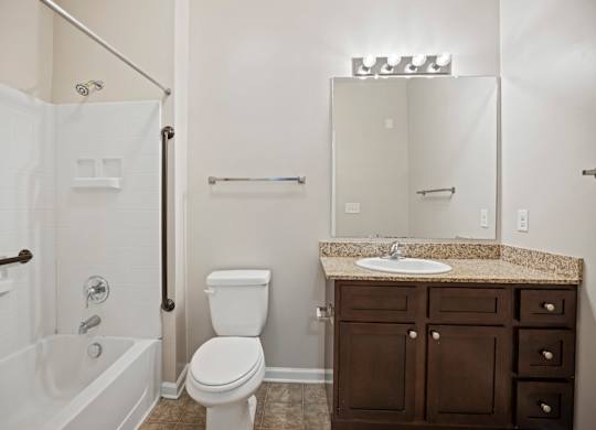 A white toilet sits next to a sink in a bathroom.