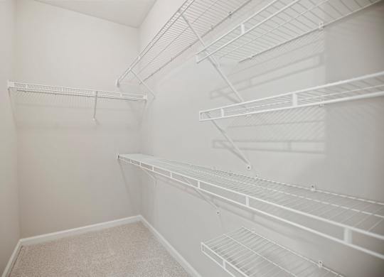 Empty white shelves in a room.