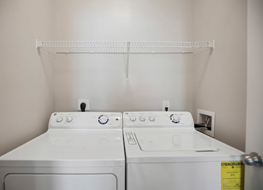 A white washing machine and dryer in a laundry room.