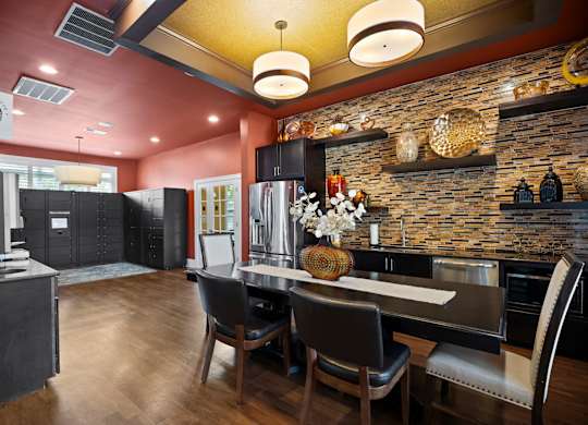 A modern kitchen with a dining table and chairs.