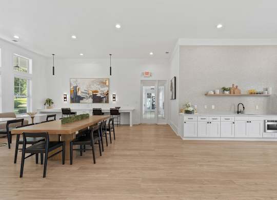 A modern kitchen with a dining table and chairs.