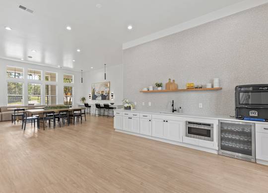 A modern kitchen with a dining table and chairs.