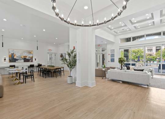 A large, well-lit room with a wooden floor and furniture.