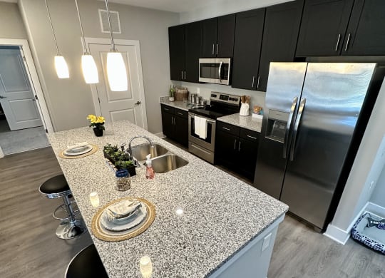 a kitchen with granite counter tops and stainless steel appliances at Barclay Place Apartments, Wilmington, NC, 28412