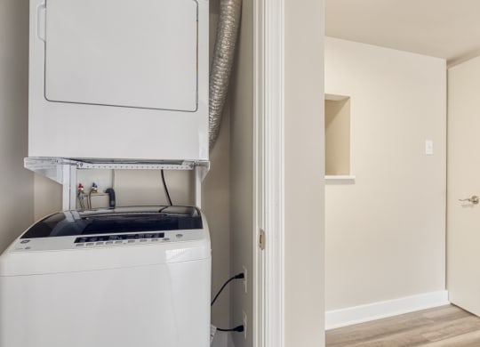 a kitchen with a stove and a refrigerator and a closet