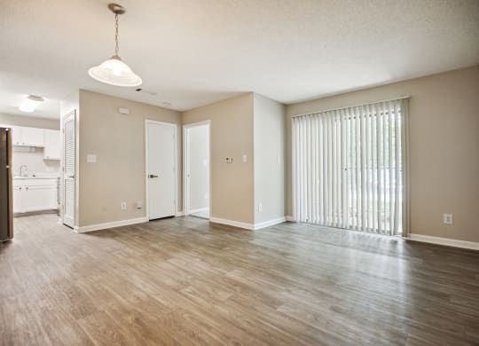 an empty living room with a large window