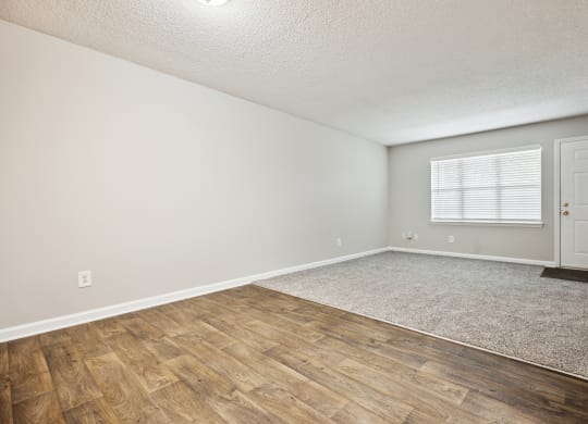 a bedroom with hardwood floors and grey walls