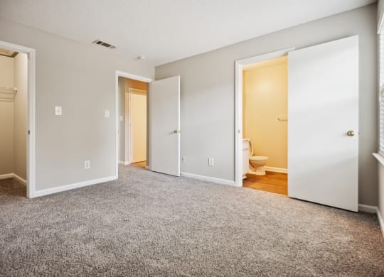 a bedroom with two doors and a toilet