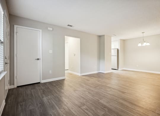 an empty living room with a hardwood floor