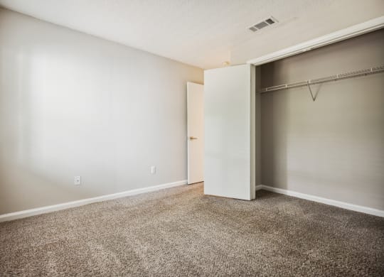 a bedroom with a closet and a window