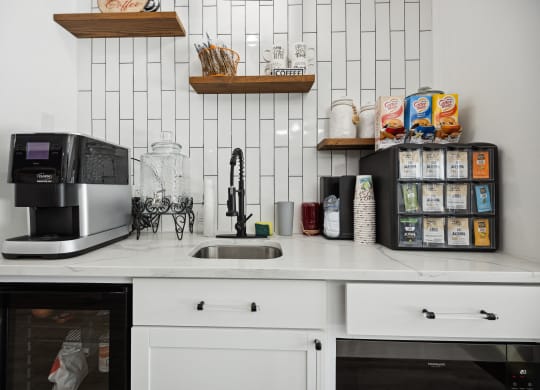 a kitchen with white cabinets and a white tile backsplash