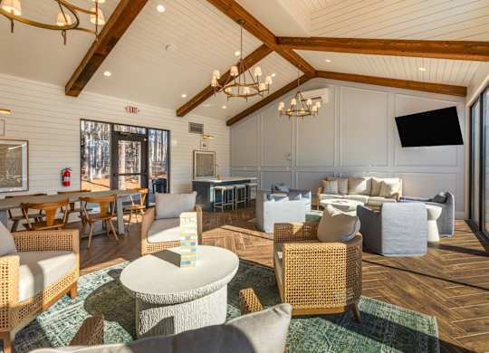 A large, well-lit room with wooden floors and furniture.