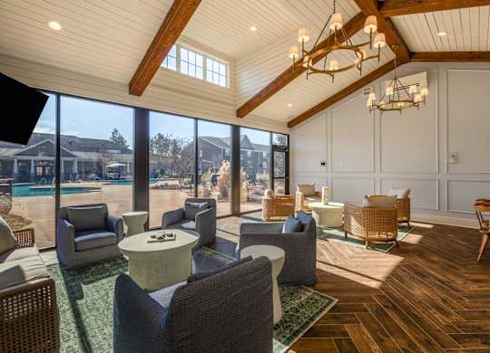 A sunny day in a spacious room with a pool outside.