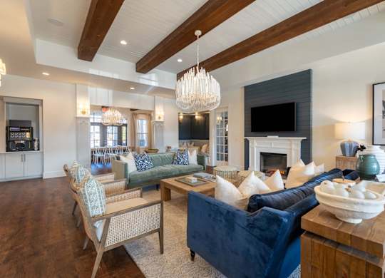 A living room with a fireplace and a blue couch.